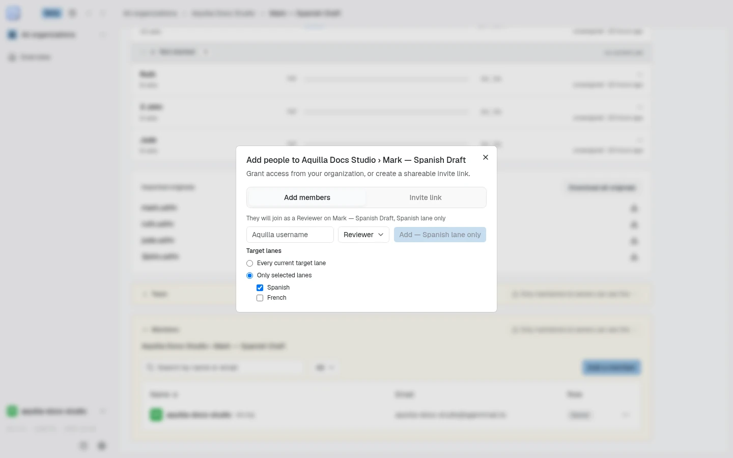 The Add people to Aquilla Docs Studio › Mark — Spanish Draft dialog on its Add members tab: the sentence "They will join as a Reviewer on Mark — Spanish Draft, Spanish lane only", an Aquilla username field, the role set to Reviewer, an Add button limited to the Spanish lane, and the Target lanes choice with Only selected lanes picked, Spanish ticked and French unticked