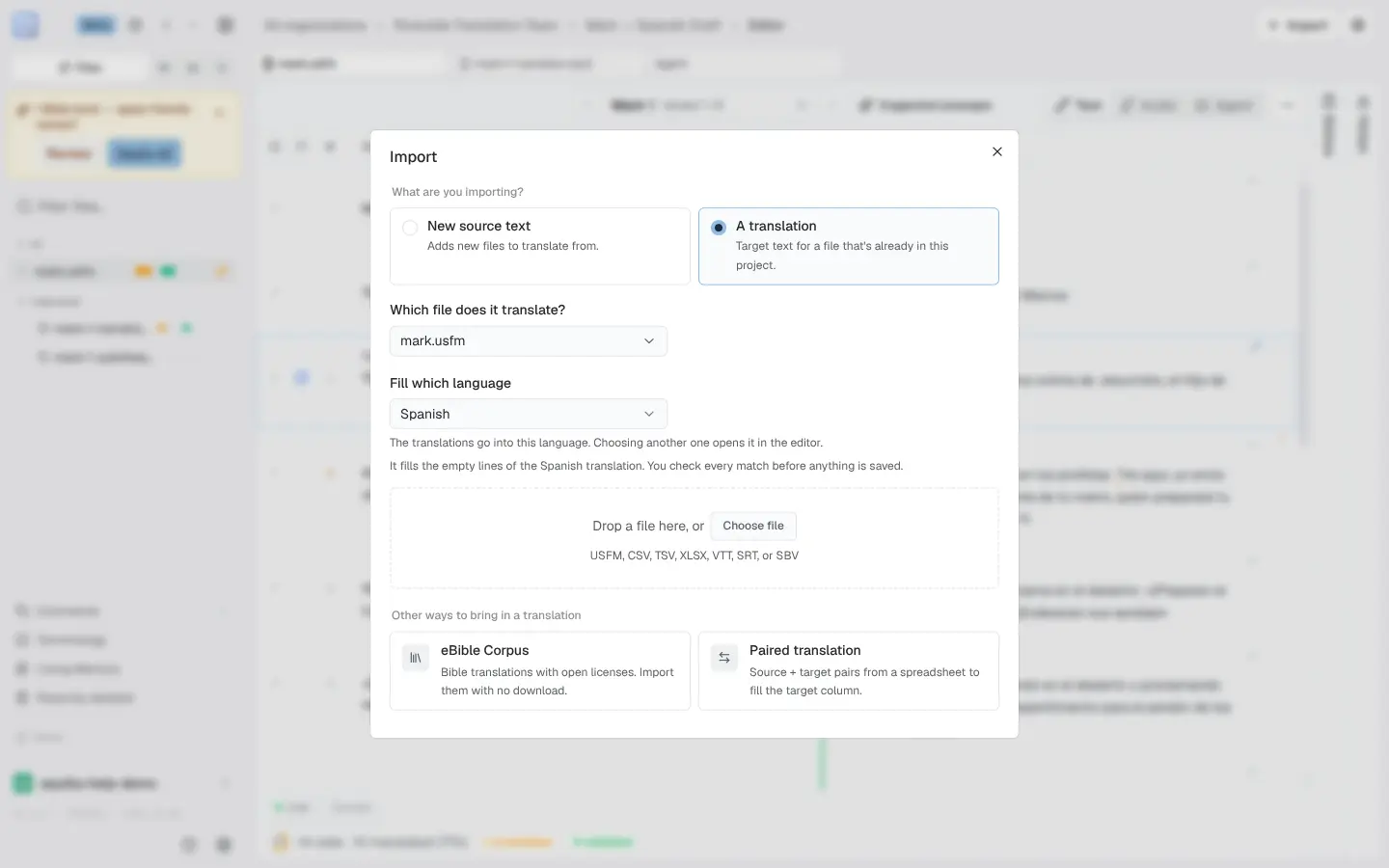 The Import dialog with A translation selected: a Which file does it translate? picker showing mark.usfm, a Fill which language picker set to Spanish, a drop zone with a Choose file button for USFM, CSV, TSV, XLSX, VTT, SRT, or SBV files, and an Other ways to bring in a translation row with eBible Corpus and Paired translation cards